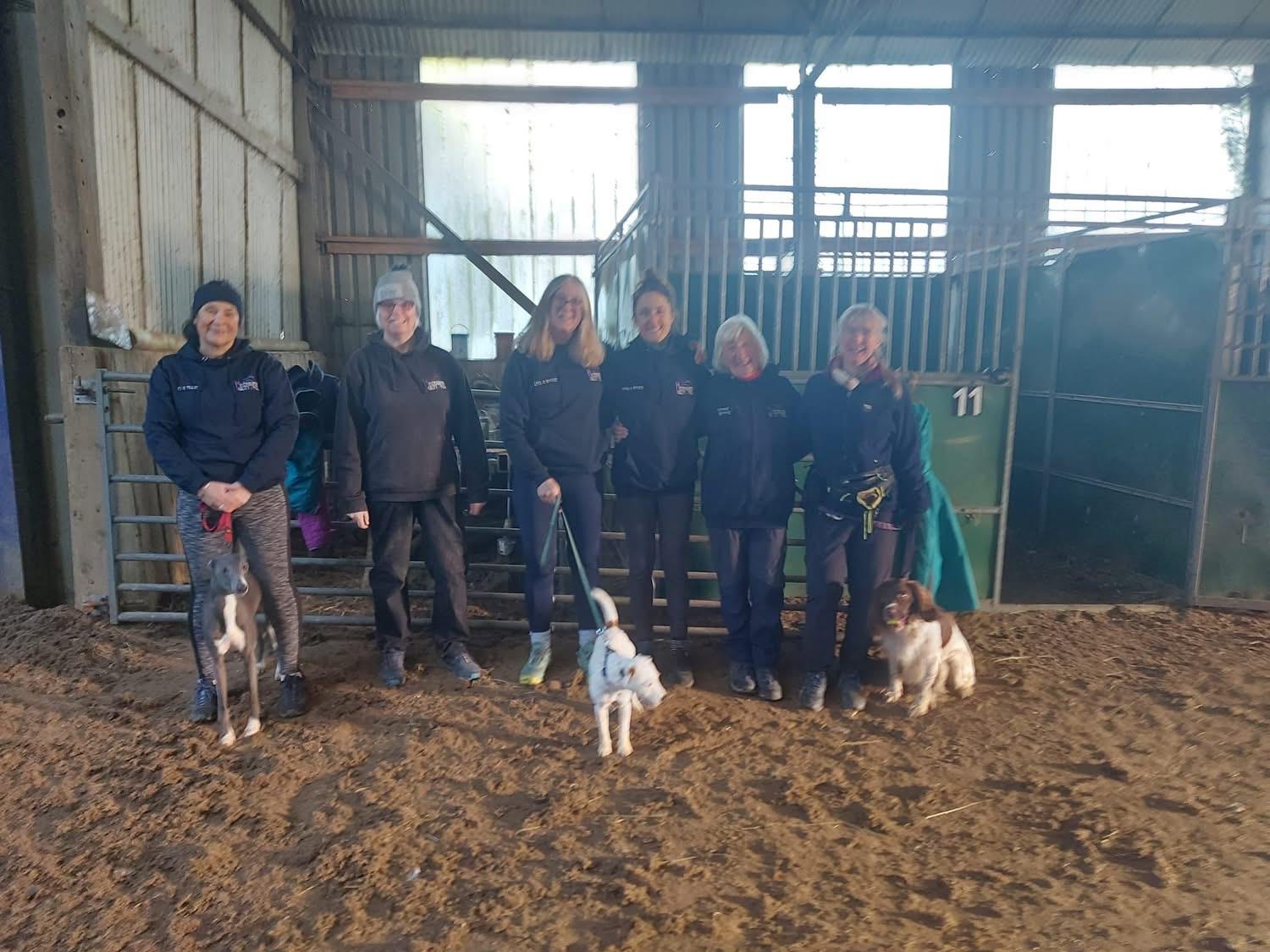 Handlers and dogs training indoors at Ardencaple Livery
