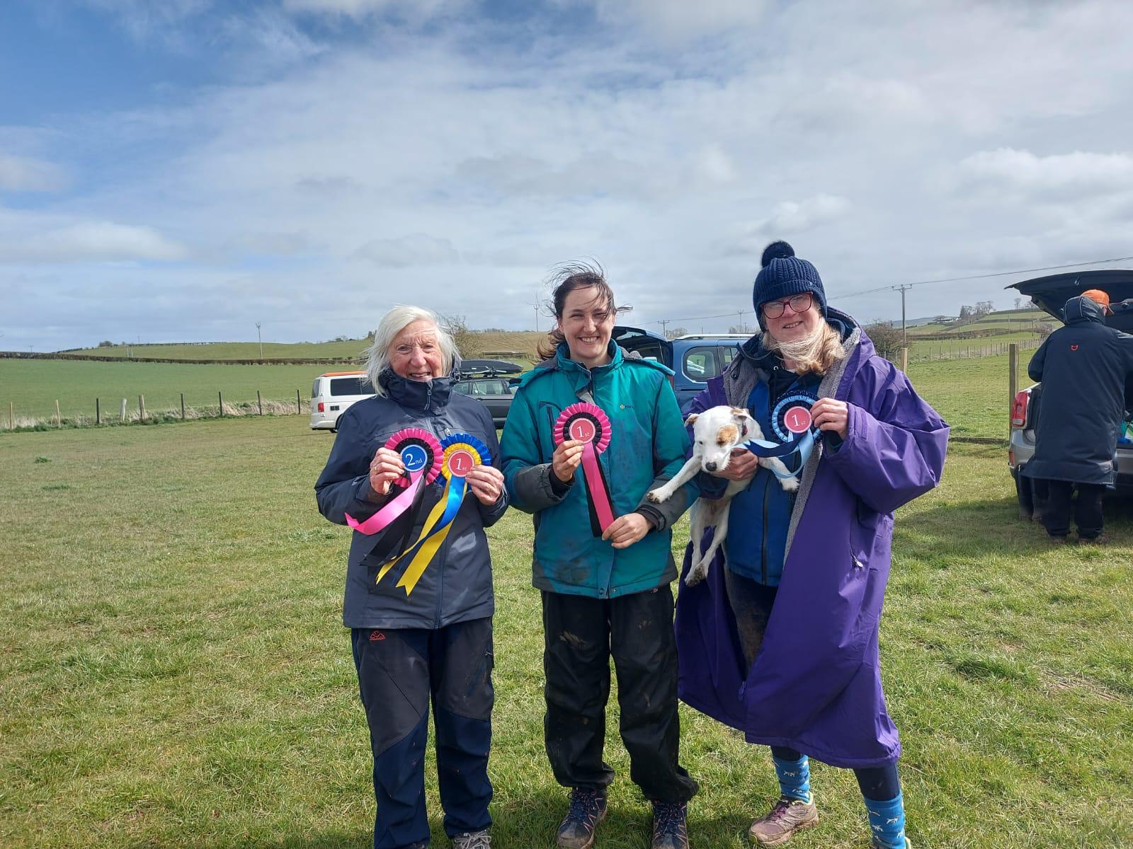 Handlers with competition rosettes