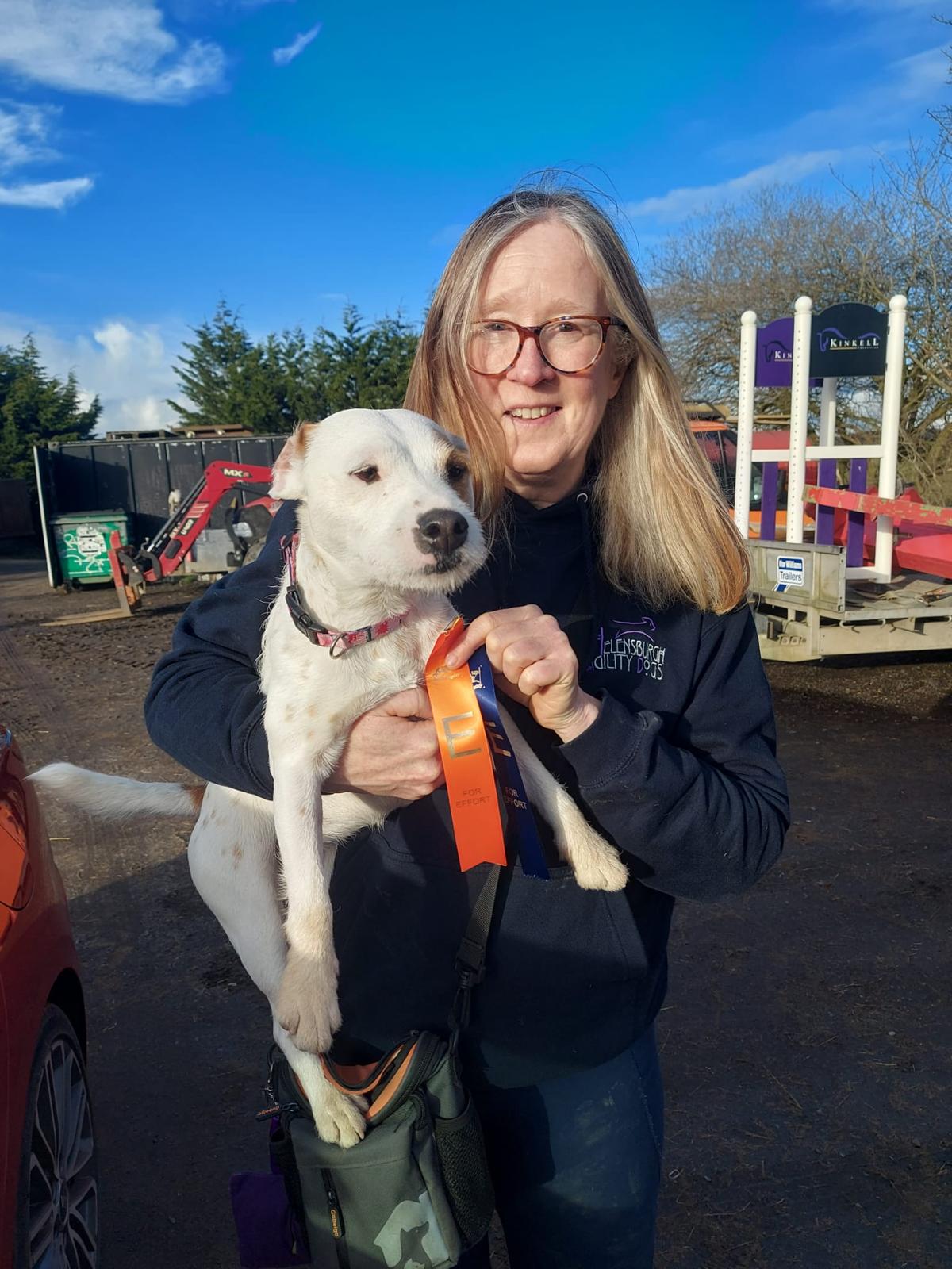 A handler with a competition rosette